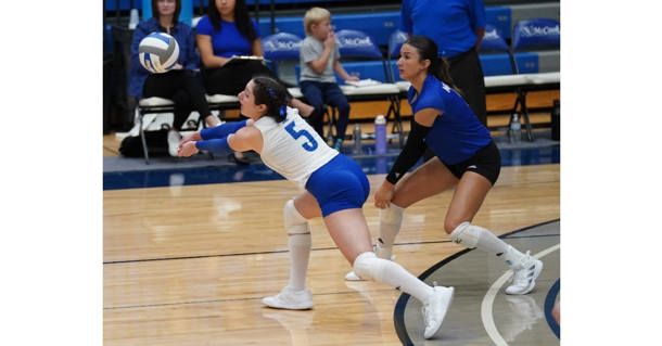 Cibeles Bothwell steps past Charlee Russick to take a pass in first-set action Tuesday against North Platte